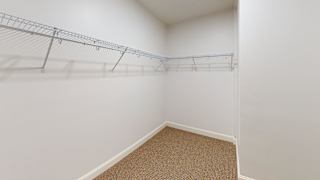 A white wall with a metal rack on it.