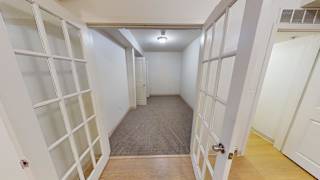Hallway with french doors and built in shelving at Bostonian Shoe Lofts Apartments, Whitman, Massachusetts