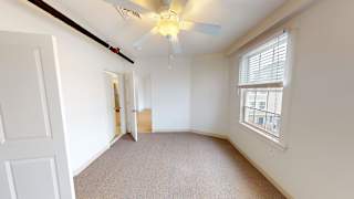 Empty bedroom with vaulted ceiling and ceiling fan at Bostonian Shoe Lofts Apartments, Massachusetts