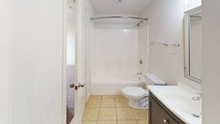 Bathroom with tub shower combo and modern vanity at Bostonian Shoe Lofts Apartments, Massachusetts, 02382