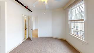 Bedroom with window blinds and ceiling light fixture at Bostonian Shoe Lofts Apartments, Whitman, 02382
