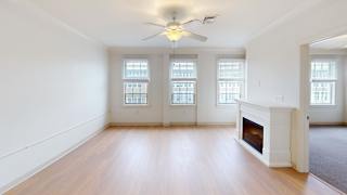 Spacious room with fireplace and three large windows at Bostonian Shoe Lofts Apartments, Whitman