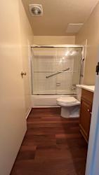 Bathroom with wood flooring at Vacaville Park Apartments, California