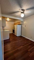 Kitchen with a white refrigerator at Vacaville Park Apartments, Vacaville, California