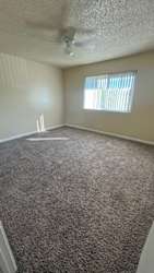 Carpeted floor and a ceiling fan at Vacaville Park Apartments, Vacaville, CA