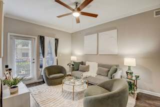 a living room with a ceiling fan and a couch at Artisan Apartments & Shops, Austin, 78729