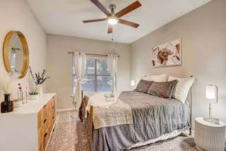 a bedroom with a bed and a ceiling fan at Artisan Apartments & Shops, Austin, Texas