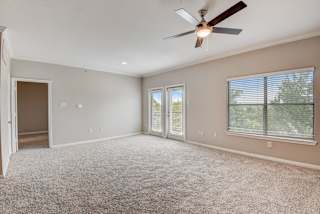 an empty living room with a ceiling fan and a window at Artisan Apartments & Shops, Austin, Texas
