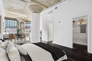 Adam Hats Lofts virtually staged bedroom area with white walls | Deep Ellum Lofts in Dallas, TX