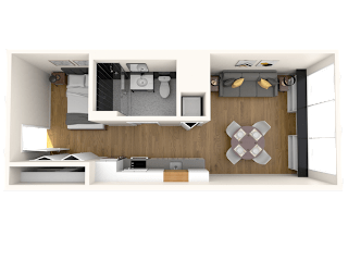 A modern living room with a grey sofa and a wooden cabinet.