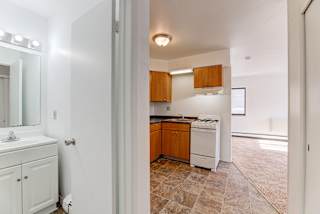 Kitchen With Bathroom View at Johnson Legacy Apartments, Milwaukee, 53223