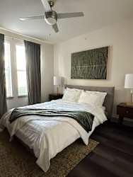 a bedroom with a bed and a ceiling fan