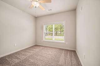 an empty room with a window and a ceiling fan at The Augustan, Augusta, 30901