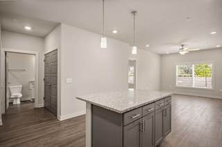 a kitchen with an island and a door to a bathroom at The Augustan, Augusta, 30901