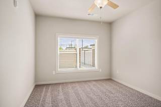 an empty room with a window and a ceiling fan at The Augustan, Augusta