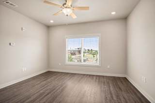 an empty living room with a window and a ceiling fan at The Augustan, Augusta