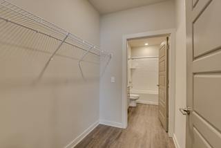 Large closet with wire shelving that opens into bathroom at The Augustan, Augusta, GA