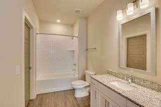 a bathroom with a shower toilet and sink and a mirror at The Augustan, Augusta