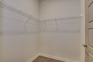 an empty closet in a home with white walls and a white door at The Augustan, Georgia, 30901