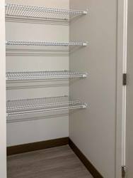 a bathroom closet with built-in shelving