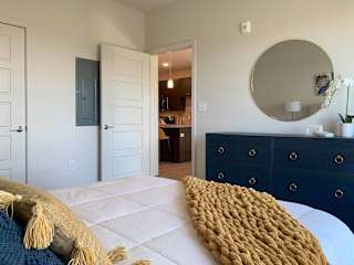 a bedroom with a large bed and a blue dresser