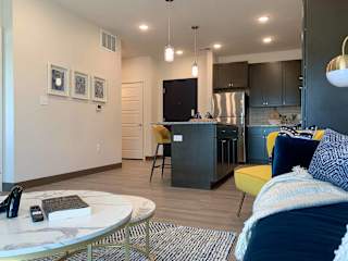 a view of the kitchen with the living room in the foreground