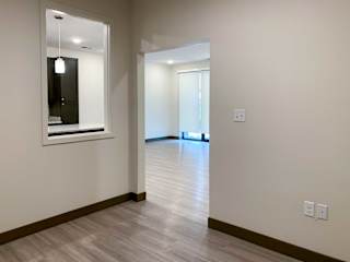 the inside of a den with hardwood floors
