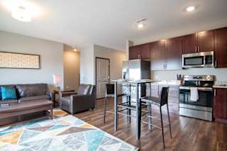 Open layout with dining and living room in a one bedroom with denat 360 at Jordan West best new apartments West Des Moines IA 50266