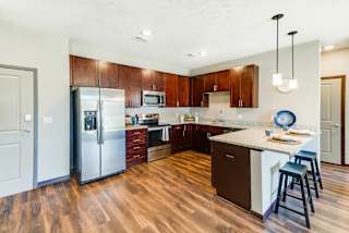 A kitchen with wooden floors and a white island.