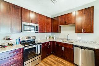 A kitchen with wooden cabinets and stainless steel appliances.