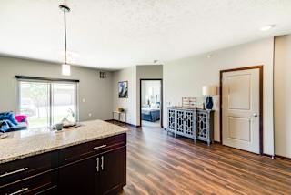A kitchen with dark wood floors and cabinets.