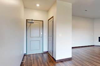 A front entryway with a coat closet next to the front door.
