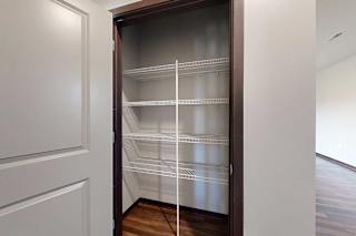 A hallway closet with built-in wire shelving, perfect for linens.