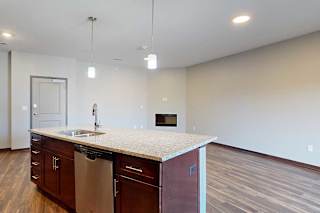 An open concept living room and kitchen, with a large central island.