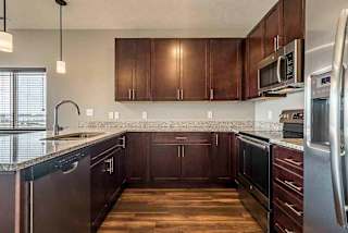 Kitchen space with updated stainless steel appliances and granite counter tops at 360 at Jordan West