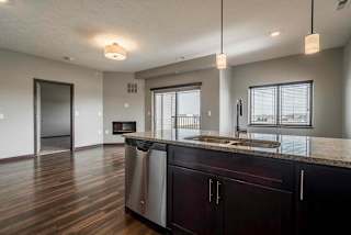 Open floor plan living room with sliding doors and windows providing natural light at 360 at Jordan West