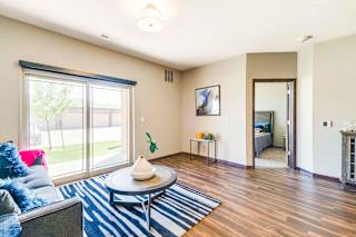 a living room with a couch and a coffee table    and a door