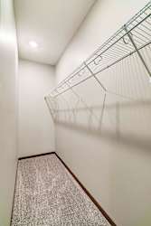 long empty walk in closet with wire clothing wrack