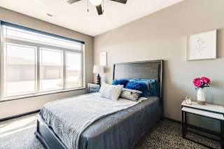 a bedroom with a large bed and a window