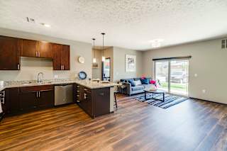 a kitchen and living room with a sliding glass door