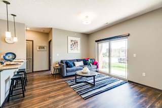 a living room with a couch and a table   and a sliding glass door