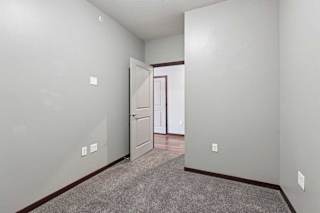 A carpeted den space with several outlets.