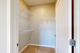 A spacious walk-in closet with built-in wire shelving.