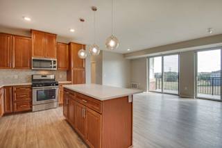 A kitchen with wooden cabinets and a white countertop.