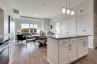 Kitchen island and living room at luxury apartment in Woodbury MN 55125