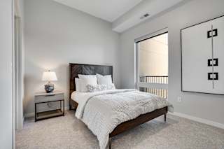 Bedroom with high ceiling and large window in two bedroom luxury apartment Woodbury MN 55125