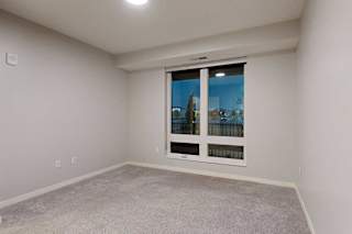 A room with a window overlooking a cityscape.