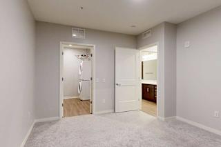 A room with a white door and a white wall.