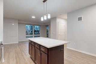 A kitchen with brown cabinets and a white countertop.