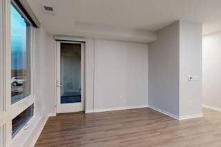 A room with a wooden floor and a sliding glass door.